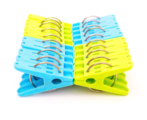 blue and green clothespins on a white background