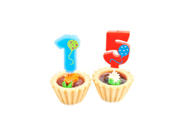 cakes with fifteen years birthday candles on white