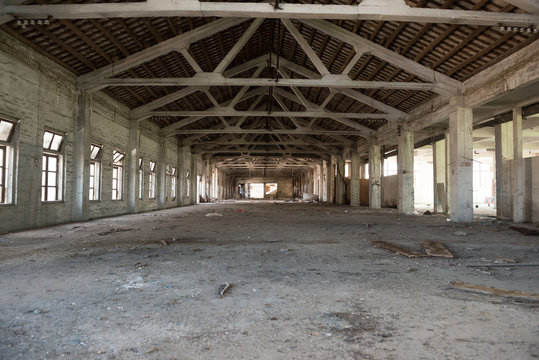 Empty industrial loft in an architectural background with bare cement walls, floors