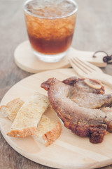 Pork steak on wooden plate