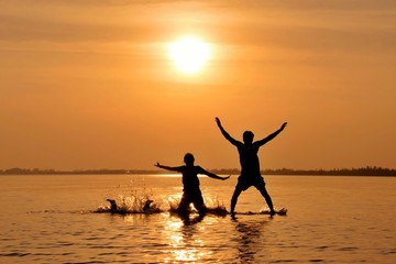 Happy children jumping on the sea