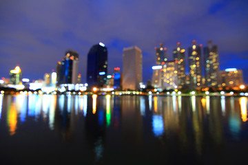 Fototapeta premium Blur reflection of the city in the lake / out focus of the city