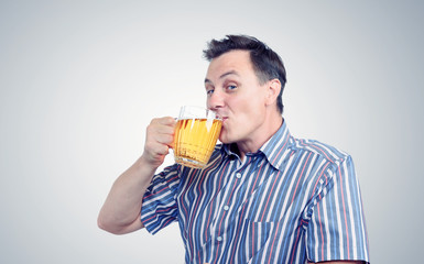 Man drinks beer from a mug