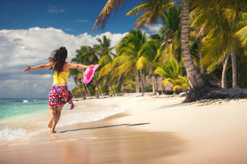 Carefree young woman relaxing on tropical beach - obrazy, fototapety, plakaty