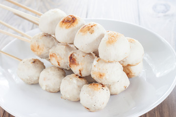 Meatball white plate placed on the table dark wood.