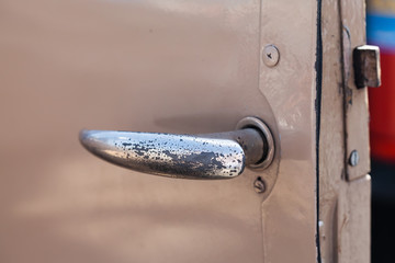Detail image of rusty old beige truck door