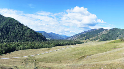 Alpine landscape with wide valley among the mountains