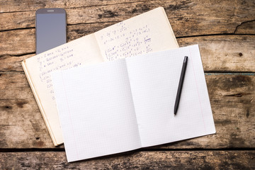 Open notebook with pen and smartphone
