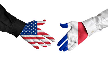 United States and France leaders shaking hands on a deal agreement