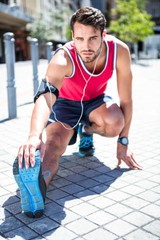 Handsome athlete doing leg stretching