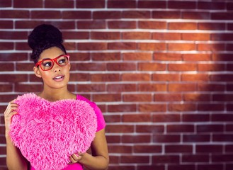 Portrait black hair model holding a pink heart shaped pillow