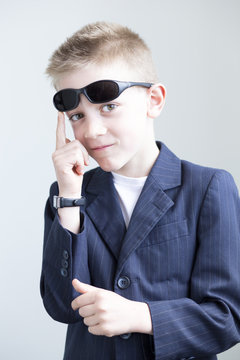 Young boy posing like a spy