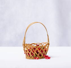 Fototapeta na wymiar cranberries in a wicker basket on a white background