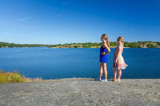 Young girls enjoy the summer sea coast view