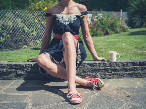 Woman drinking tea in garden