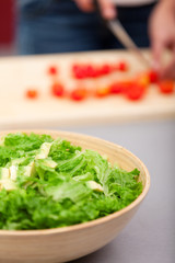 Young woman making salad