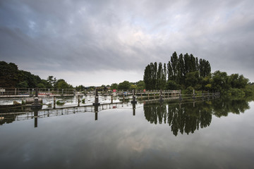 Dawn landscape Chertsey Lock and weir over River Thames in Londo