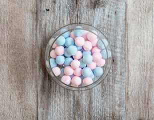 pink and blue candies on a wooden background
