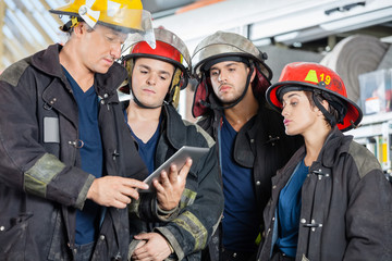 Fototapeta premium Firefighters Using Tablet Computer