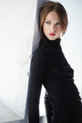 Portrait of brunette slim woman in black clothing.