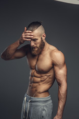 Fototapeta premium Shirtless muscular bodybuilder with beard
