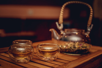 Teapot with herbs and cups.