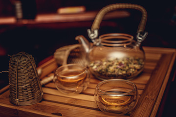 Teapot with herbs and cups.