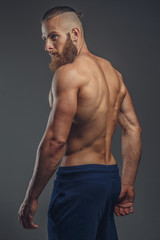 Fototapeta na wymiar Shirtless muscular bodybuilder with beard