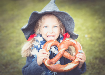 little bavarian girl with a big pretzel.