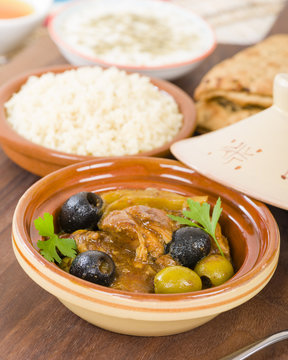 Chicken Tagine - Moroccan chicken tagine with olives, preserved lemon and fennel, served bulgur wheat.
