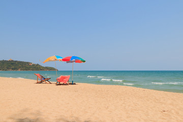 Beach chair and umbrella on sand beach