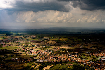 The town of Monsummano Terme lighting by a sunbeam during a storm