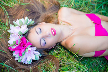 Pretty young lady in wreath with closed eyes