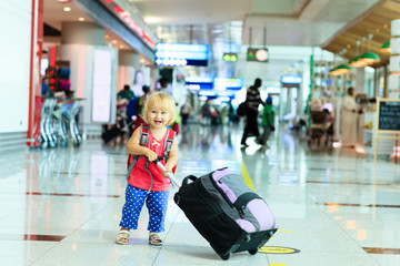 little girl with suitcase travel in the airport
