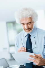 Fototapeta premium Confident businessman reading paperwork