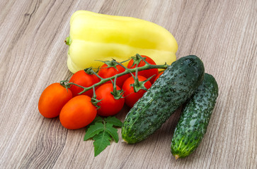Cucumbers and tomatoes on the branch with yellow pepper