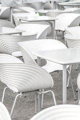 White chairs and tables geometry close-up