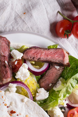 Mexican tortillas with green fresh salad filling, beef, onions, tomatoes with gucamole and tortilla chips on te vintage board
