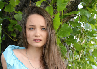 Young attractive woman close up portrait near tree