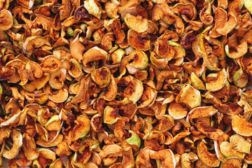 Background of dried apples, yellow and orange slices
