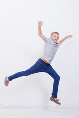 happy young boy jumping  on white background