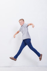 happy young boy jumping  on white background