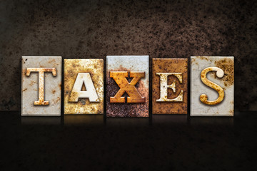 Taxes Letterpress Concept on Dark Background