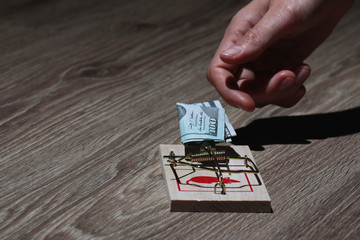 Mousetrap with dollars hand