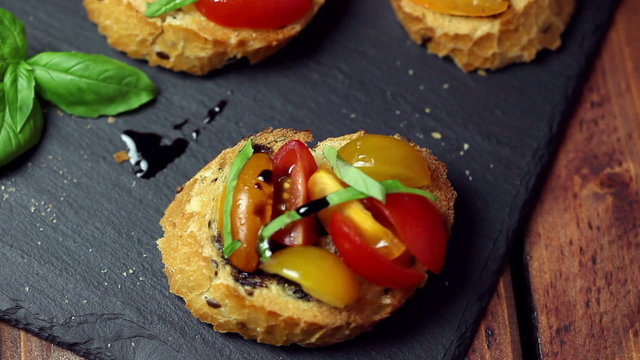 freshly prepared bruschetta on the old wooden background 