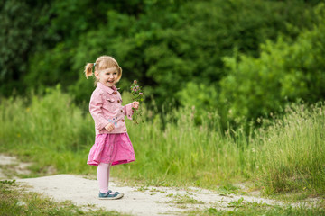 Naklejka premium Cute little girl on the meadow 