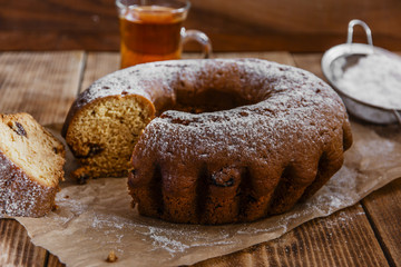 bake ring cake with icing sugar sliced and raisins