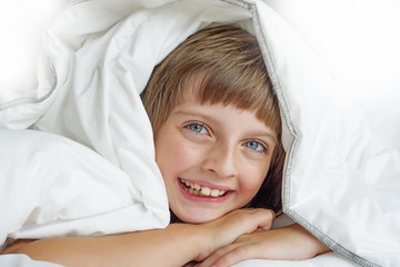 happy little girl resting in a bed