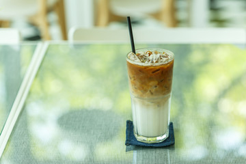Fresh ice coffee in big glass with straw