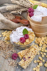 A fruit and nut ceral protein bars with raspberries and sour cream and cornflakes